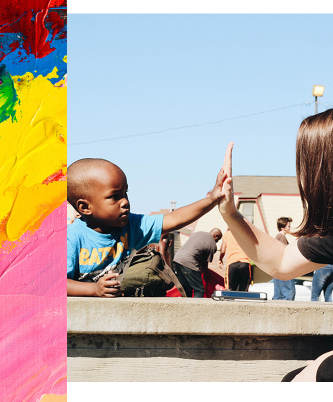 Small boy high-fiving woman